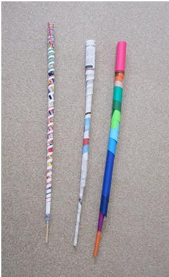 島縞模様やカラフルな色合いの細長い紙の棒が3つ並んでいる写真