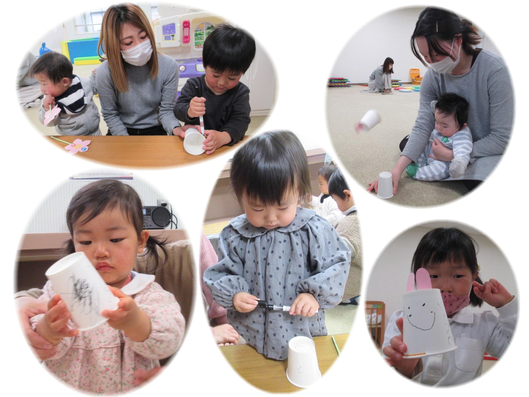 紙コップに動物の顔などを描いている子供たちの写真