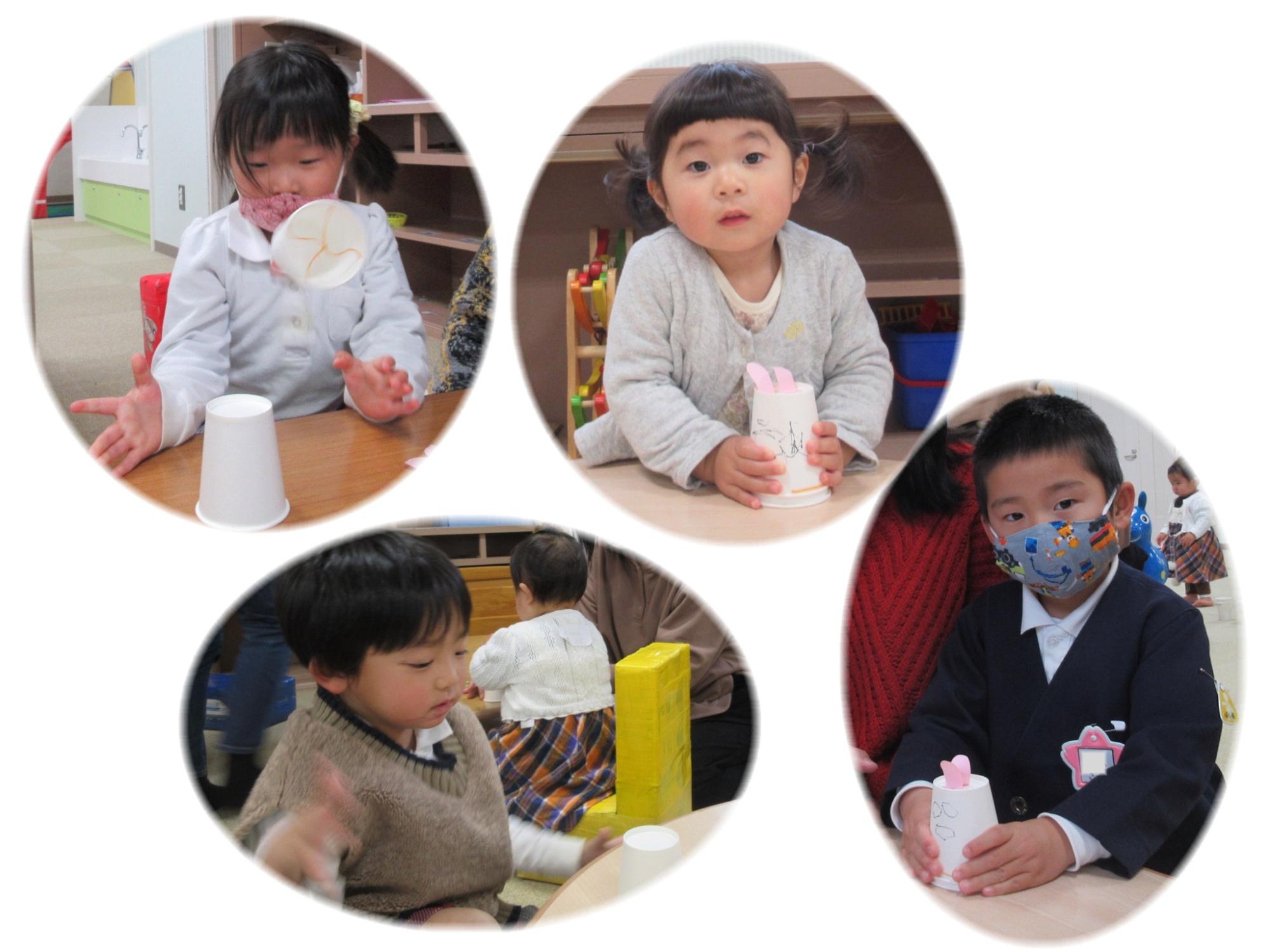 工作した紙コップを持っている子供たちの写真