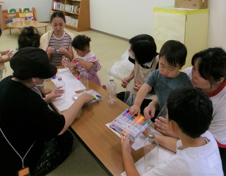 7月のうたとおはなしの広場で工作をする親子