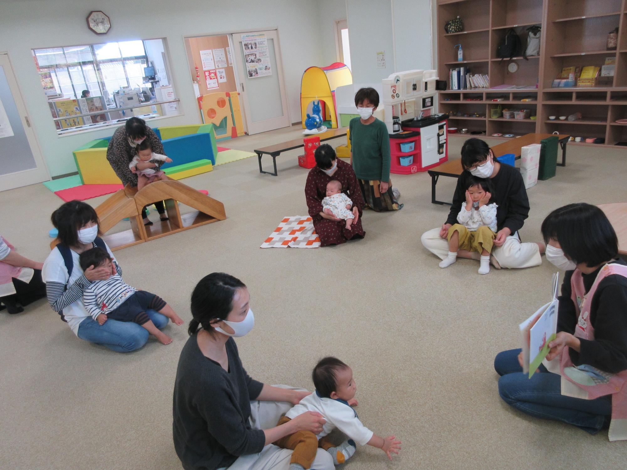 遊具のあるプレイルームで親子たちが遊んでいる写真