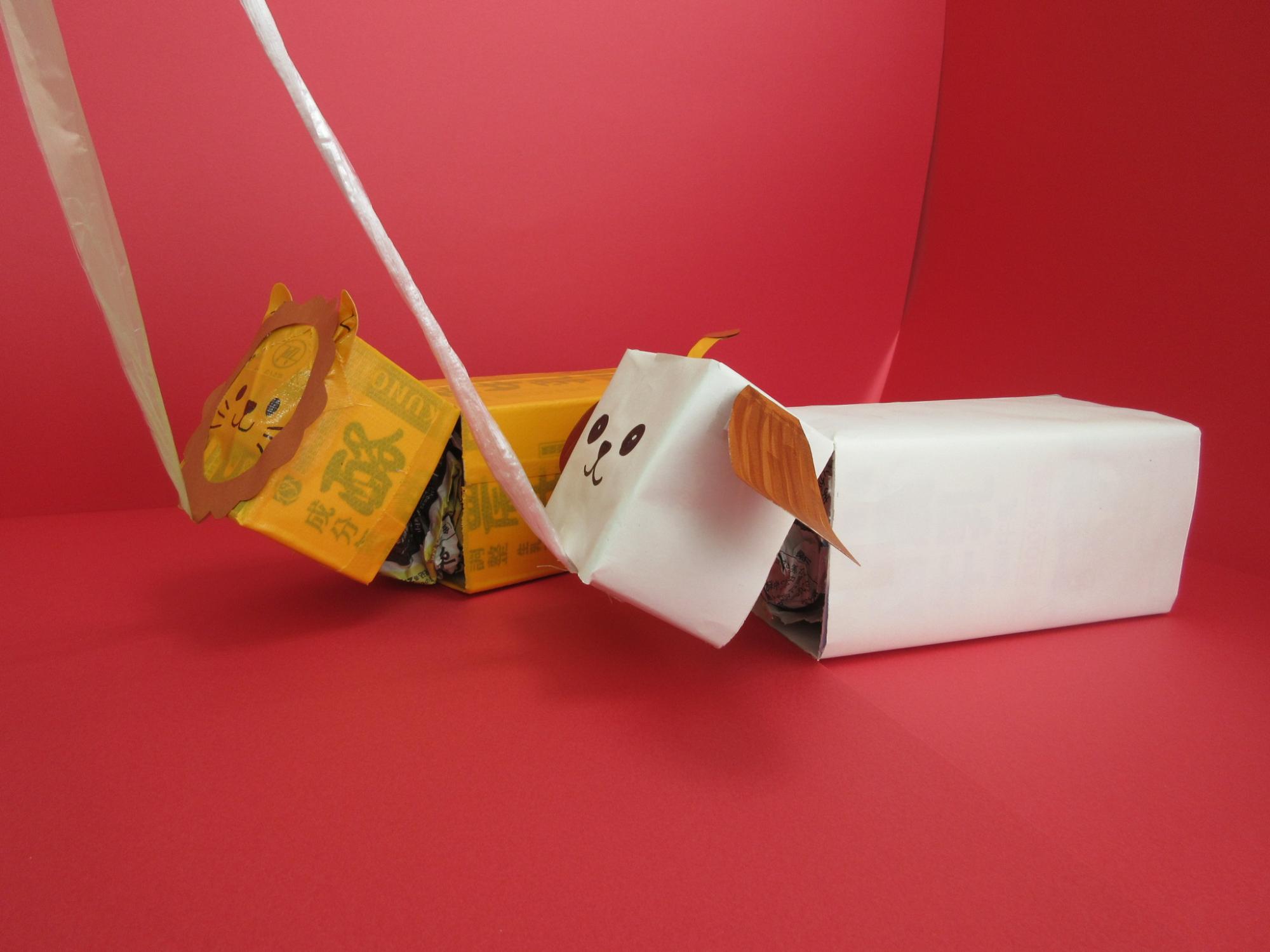 猫や犬の見た目をした箱が紐で吊るされている写真