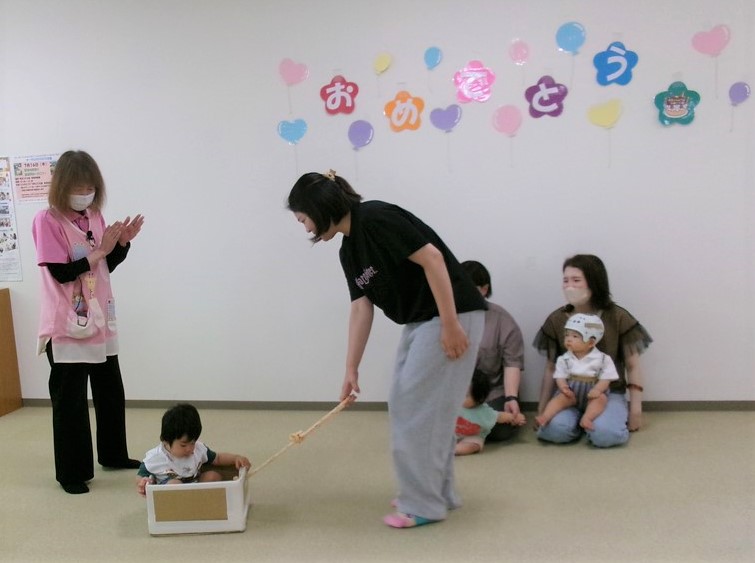 赤ちゃんと遊ぶ親子の様子