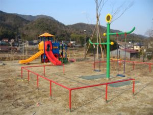 ブランコや滑り台のある子ども広場の写真