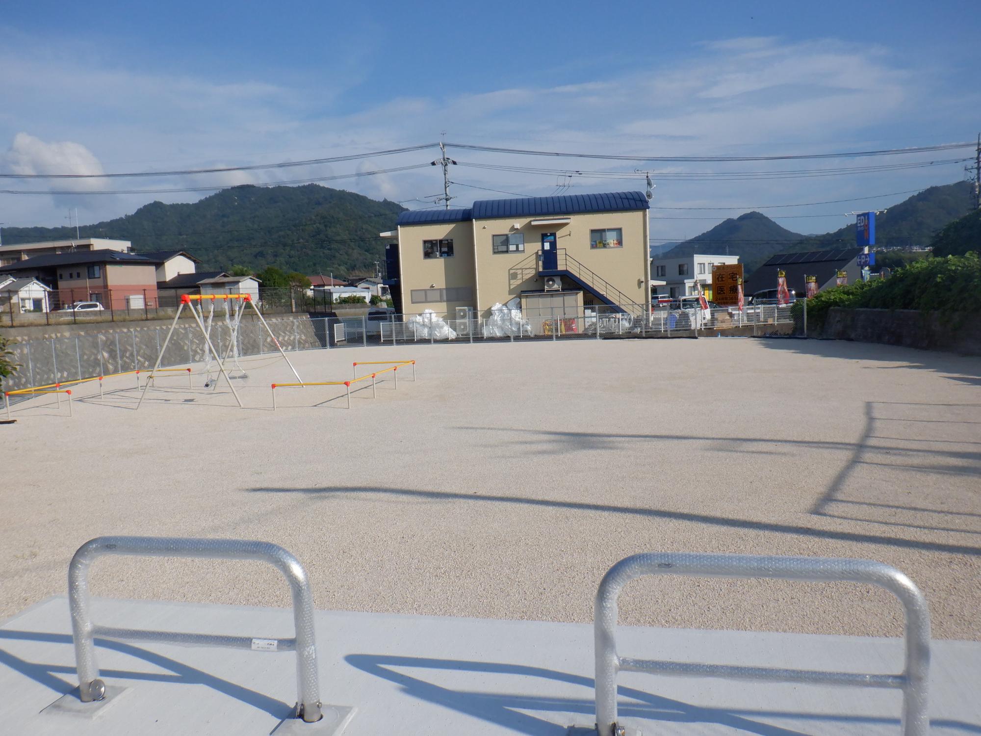 白いフェンスに囲まれた敷地にブランコがある中筋公園の写真