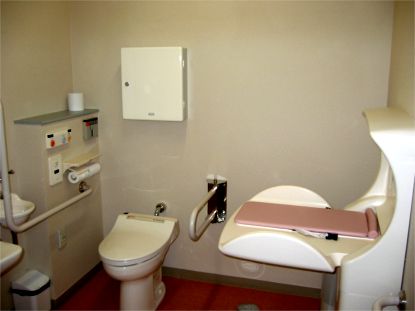 手すりやおむつ交換台がついた多目的トイレの写真
